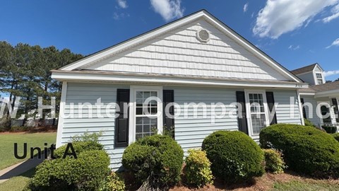 A white house with Unit A written on the front.
