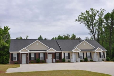 A house with a grey roof and white doors.