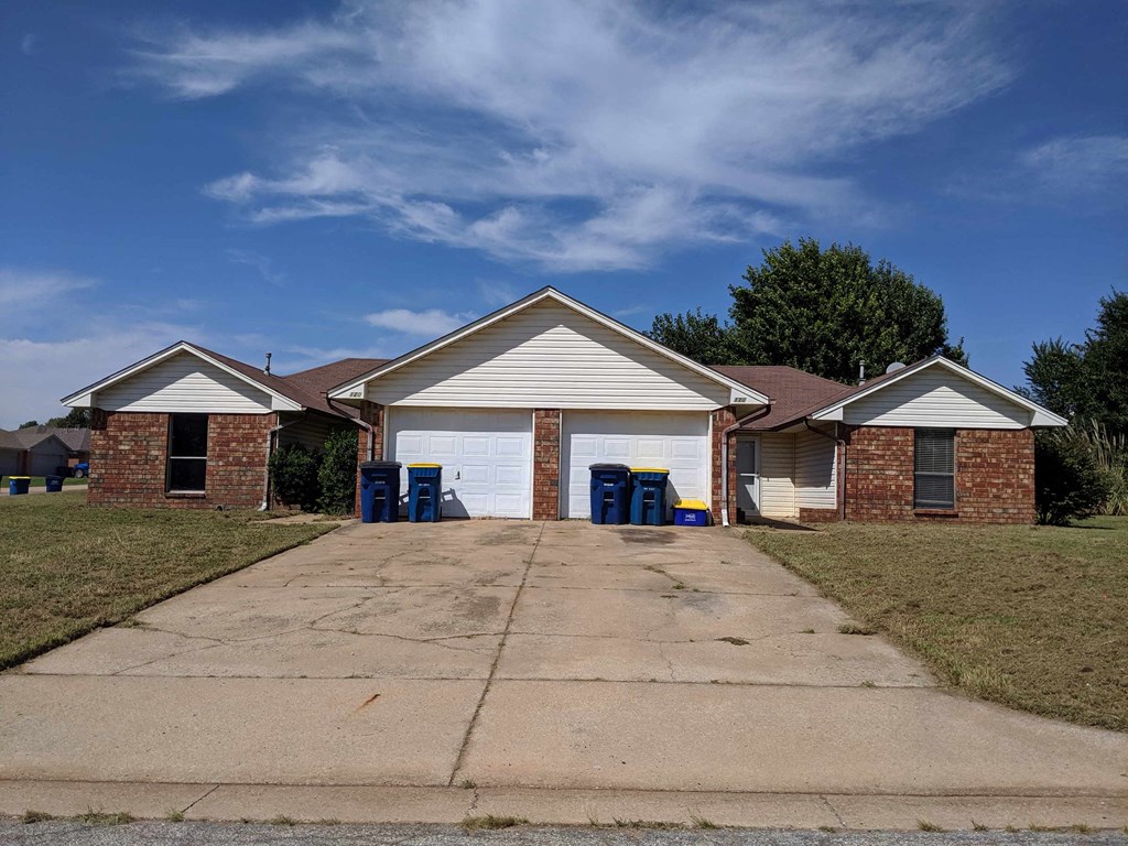 a house with a driveway and a white garage door