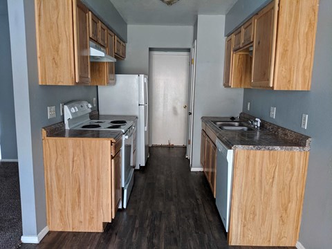 a kitchen with wooden cabinets and a white refrigerator