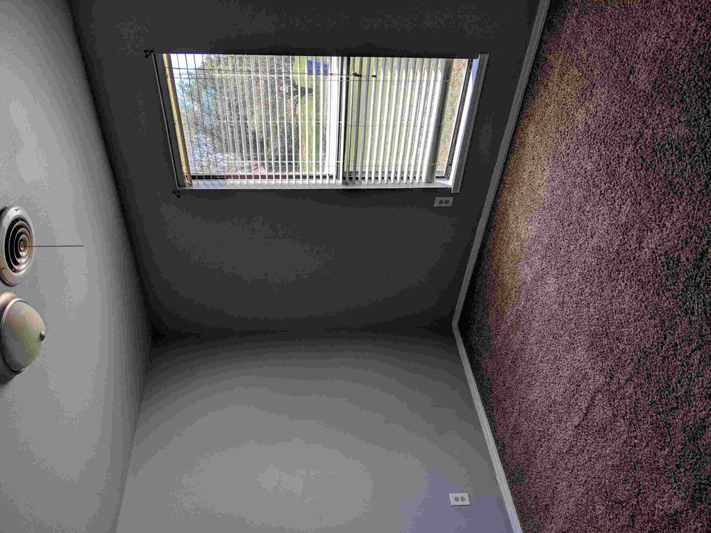 a small room with a window and a door