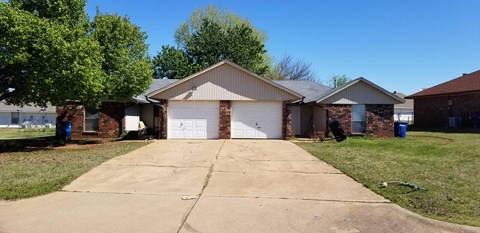 a house with a driveway and a white garage door