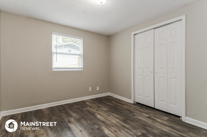 the upstairs bedroom with two closets and a window