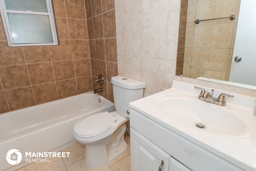 a bathroom with a sink toilet and a bath tub