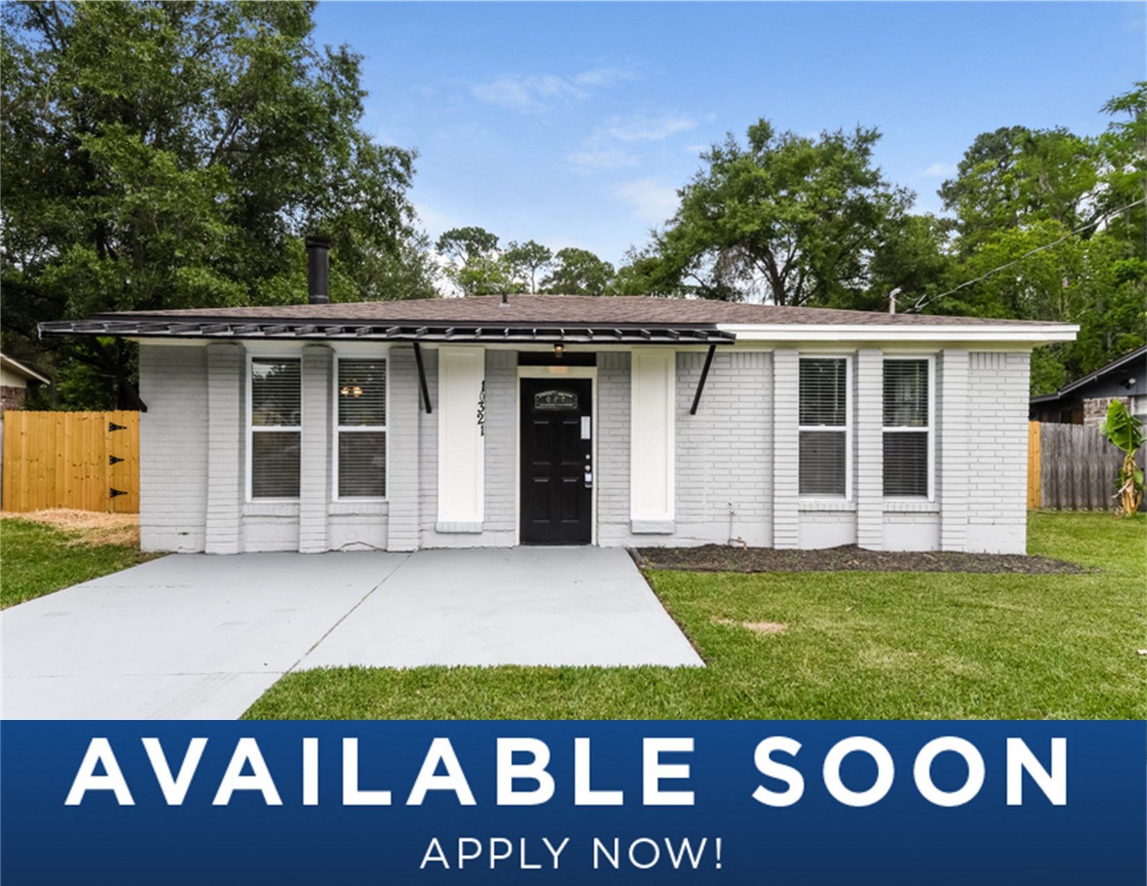 a small white house with a yard and a driveway