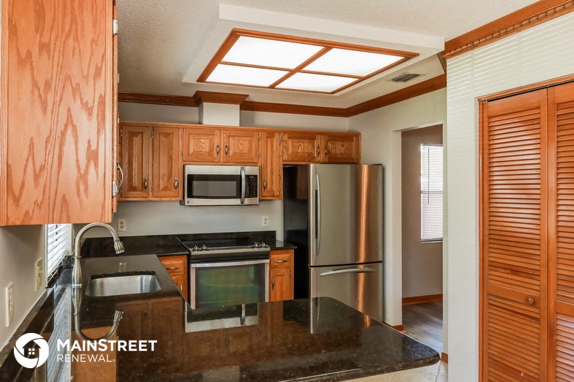 a kitchen with wooden cabinets and stainless steel appliances