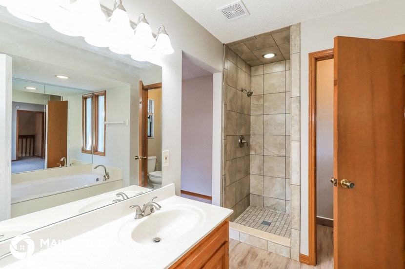 a full view of a bathroom with a sink and a shower