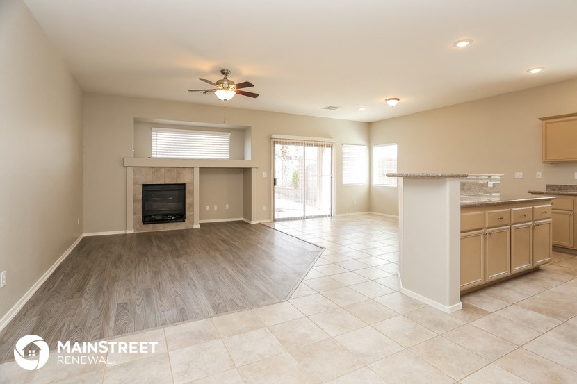 an open kitchen and living room with a fireplace