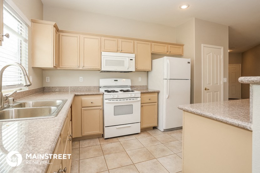 a kitchen with white appliances and granite counter tops