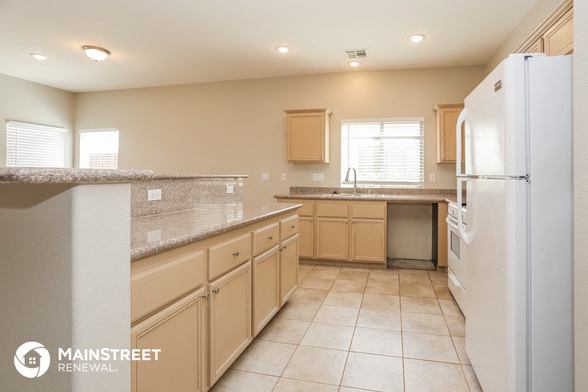 a kitchen with white appliances and granite counter tops
