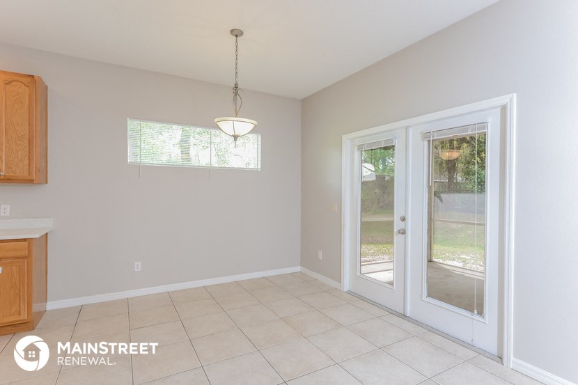 a dining room with a door to the backyard