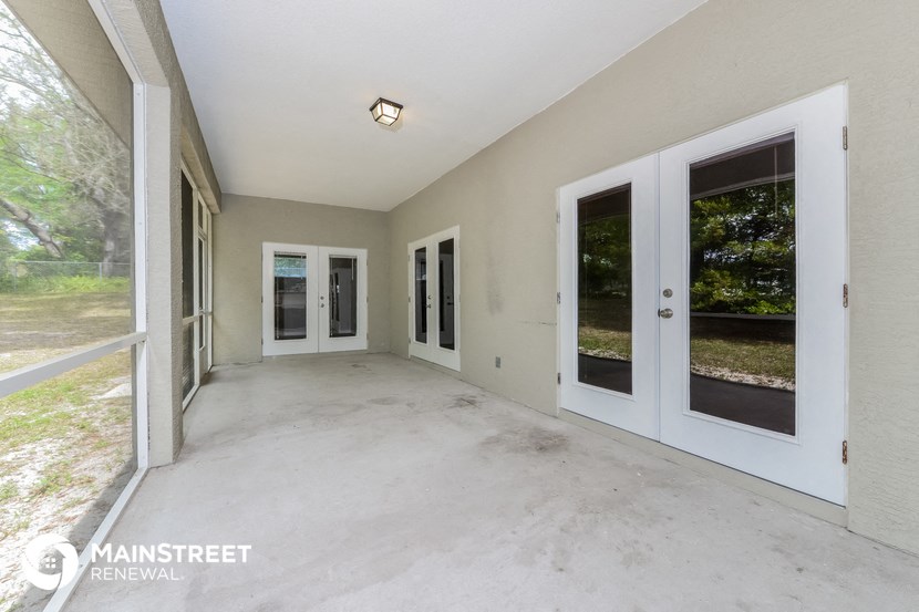 a spacious living room doors and a patio