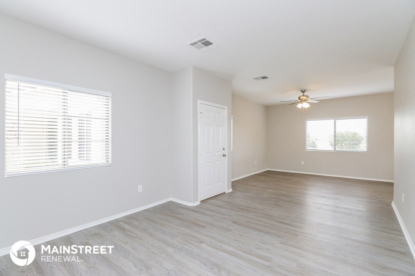 the living room and dining room of an apartment