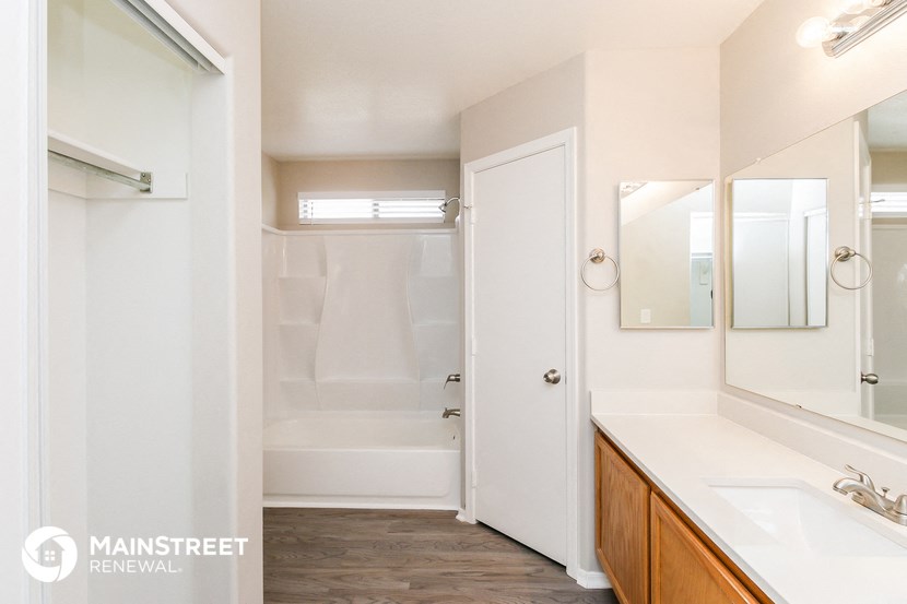 a bathroom with a shower and a sink and a mirror