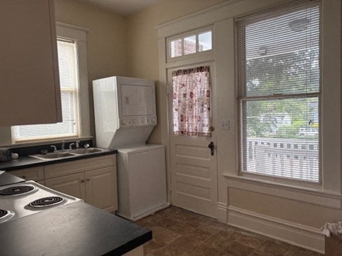 A kitchen with a stove top oven and a refrigerator.