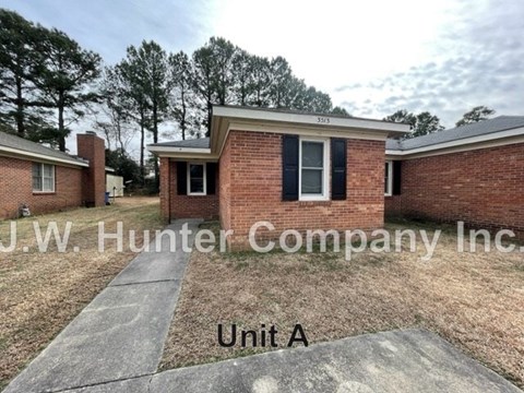 A brick building with the sign J.W. Hunter Company Inc. in front of it.