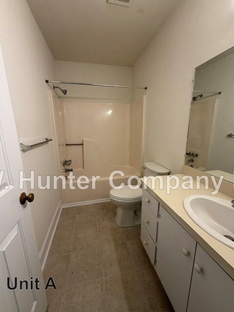 A Hunter Company bathroom with a toilet, sink and shower.