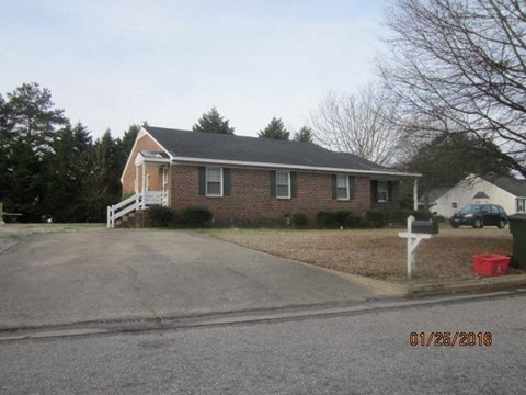 a brick house on the corner of a street