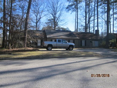 a white truck parked in front of a house