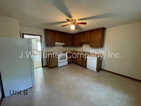 A J.W. Hunter Company, Inc. logo is on the wall of a kitchen.