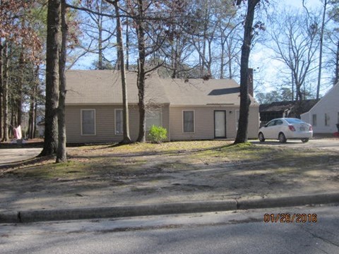 a house with a car parked in front of it