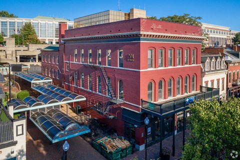 A red building with a blue awning in the foreground.