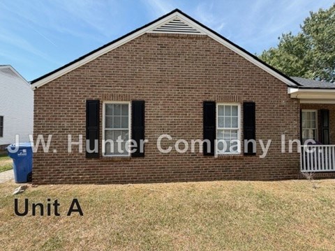 A brick house with the text J.W. Hunter Company Inc. Unit A on it.