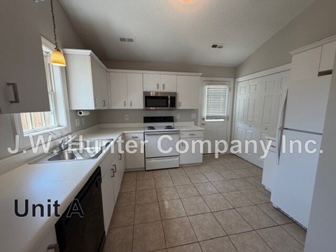 A kitchen with white cabinets and appliances is on the market with J.W. Hunter Company Inc.