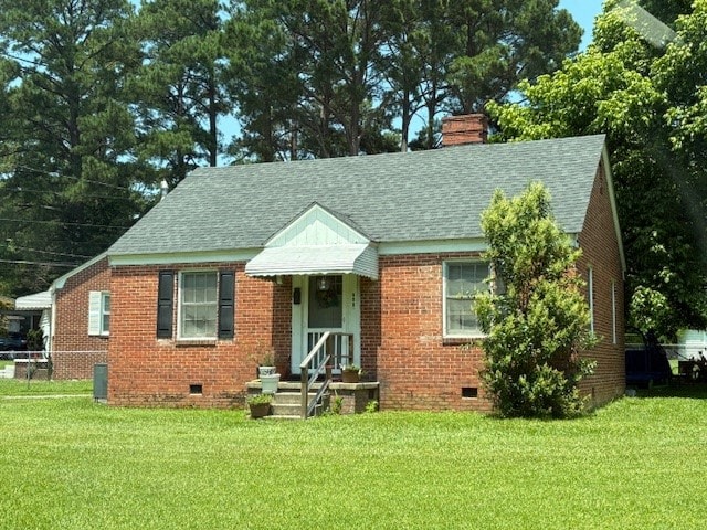 A small red brick house with a green roof and a white door.