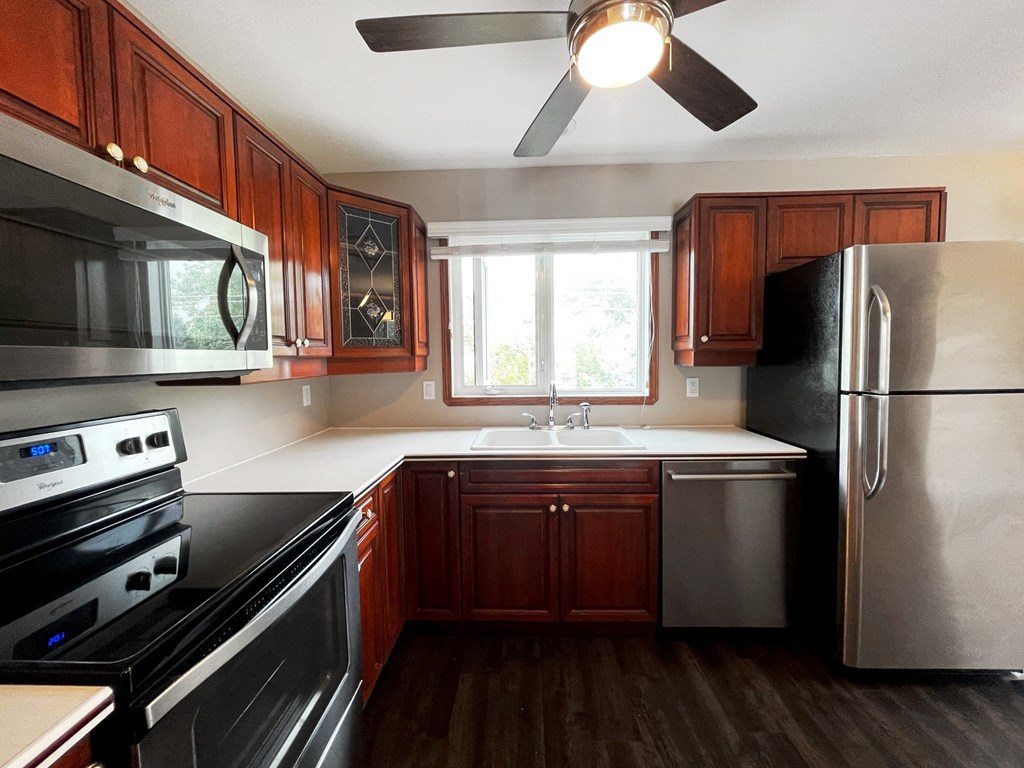 a kitchen with stainless steel appliances and wooden cabinets