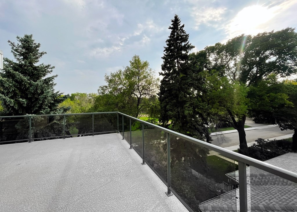 the view from the top of a ramp overlooking a park and trees