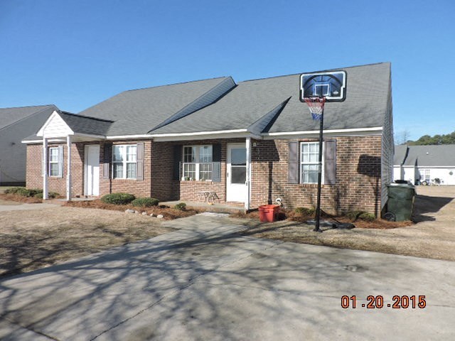 a basketball hoop in front of a brick house