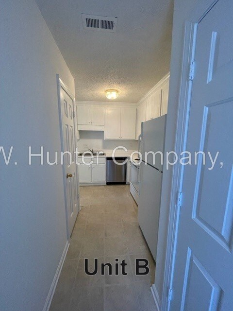 A hallway in a building with the words "Unit B" on the floor.