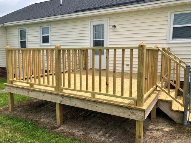 a wooden deck in front of a house