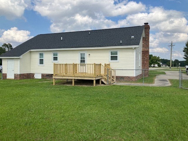 a white house with a wooden deck in the yard