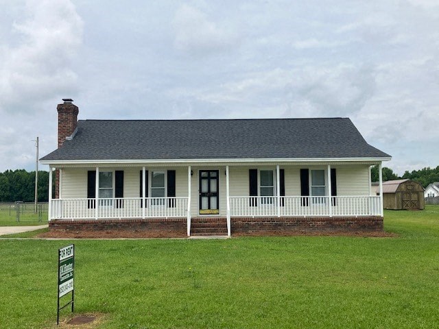 a white house with a white porch and a sign