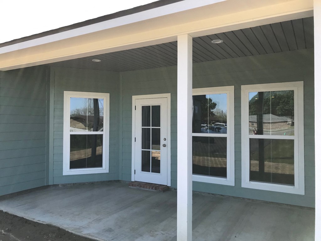 the windows and doors are installed on the front porch of a home