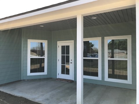the windows and doors are installed on the front porch of a home