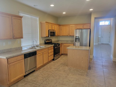 A kitchen with wooden cabinets and stainless steel appliances.