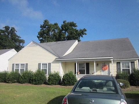 a house with a car parked in front of it