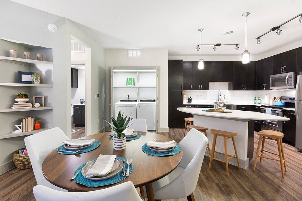 an open kitchen and dining area with a table and chairs
