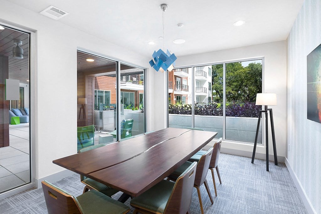 a dining room with a wooden table and chairs