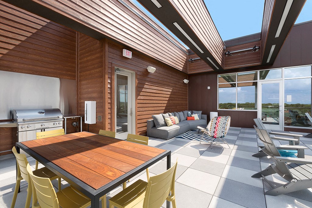 a kitchen and living room with a wooden table