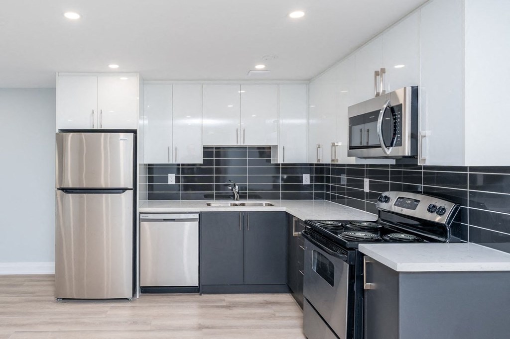 a kitchen with stainless steel appliances and white cabinets