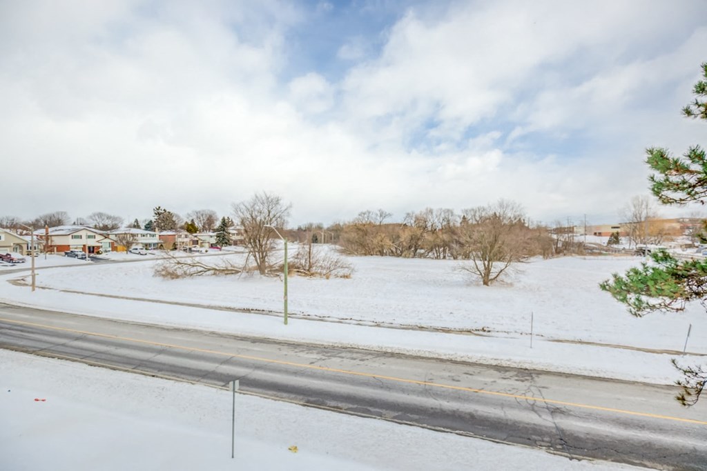 the view of a snowy neighbourhood from a street