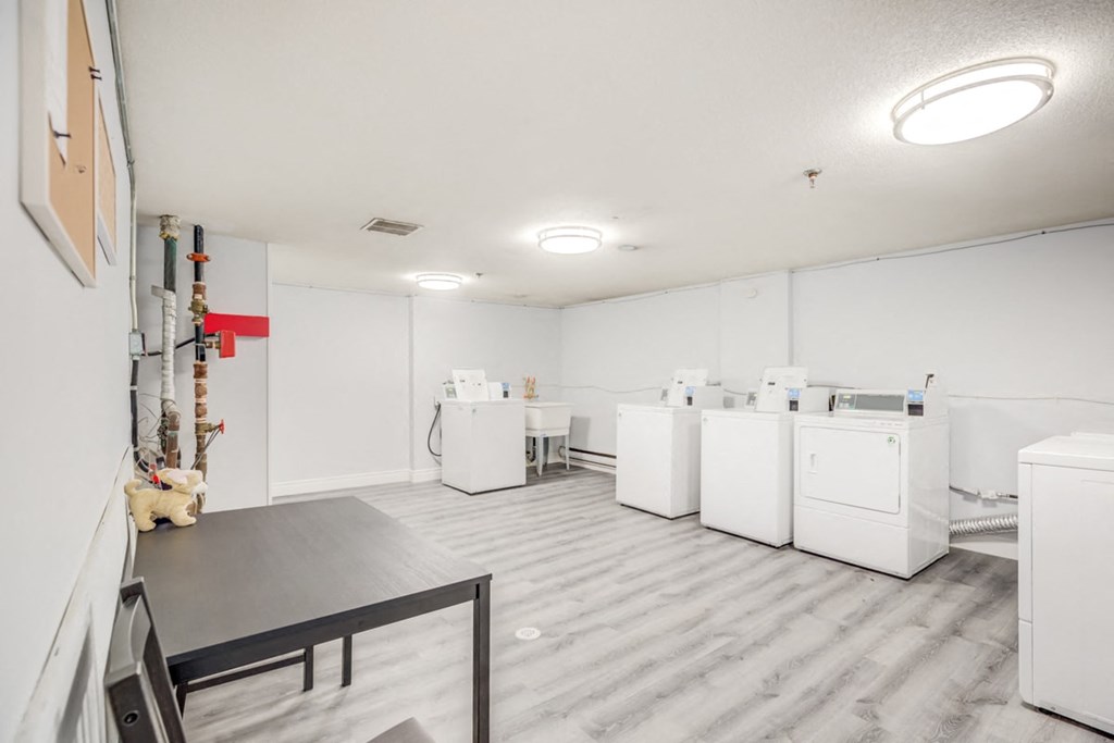 our laundry room is equipped with washes and dryers and a table
