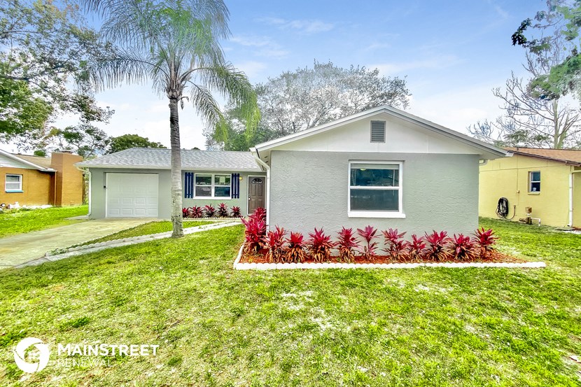 a house with a yard and a palm tree