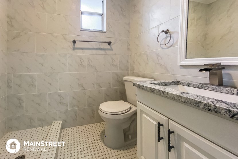 a bathroom with a toilet and a sink and a mirror