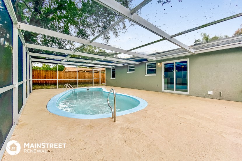 a hot tub in a patio next to a swimming pool