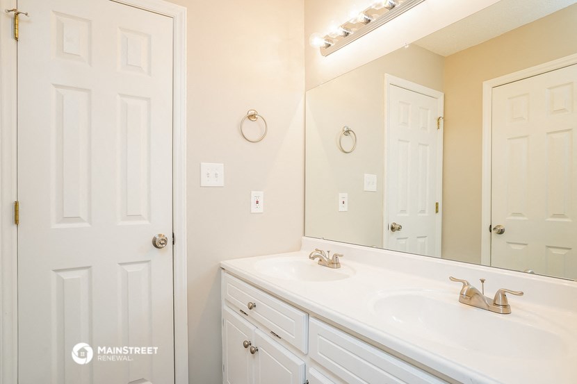 a bathroom with two sinks and a large mirror